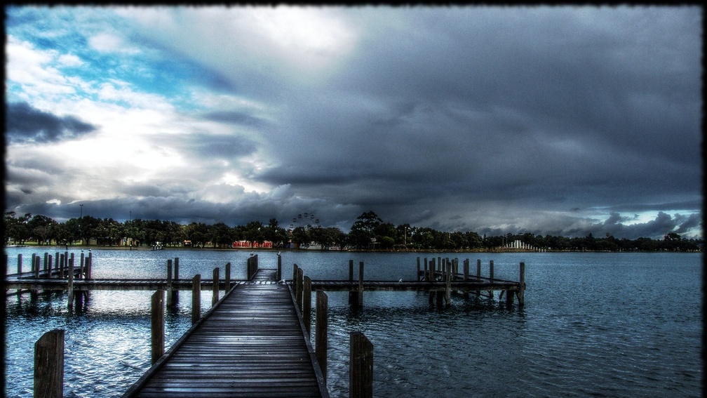 docks on a lake under stormy sky