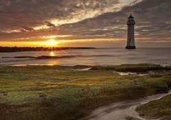 beautiful lighthouse off shore at sunrise