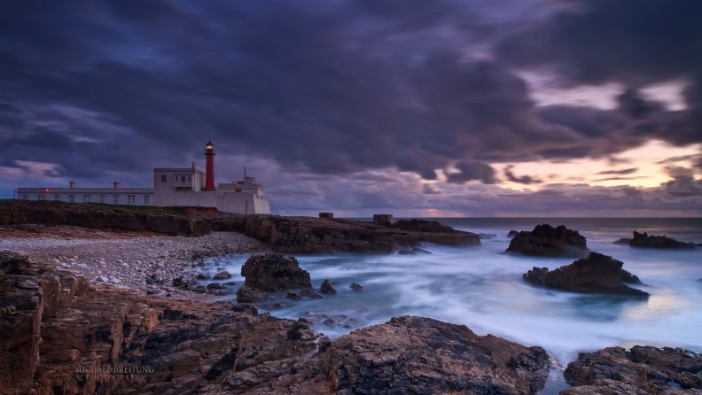 beautiful portuguese lighthouse on rocky shore
