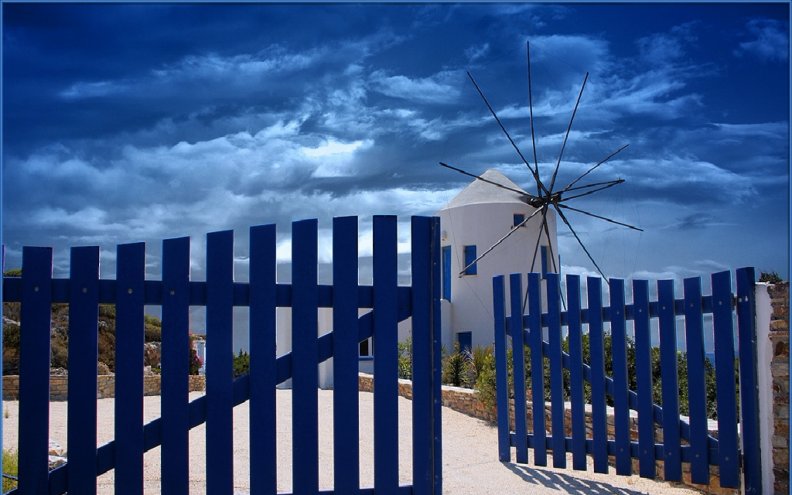 greek_windmill_behind_blue_fence.jpg