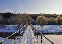 foot bridge over river in winter