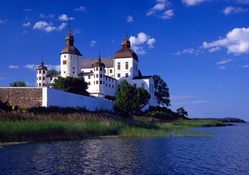white castle on a lake shore