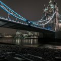 tower bridge in london from the river bank