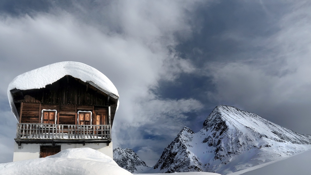snow covered chalet up high in the mountains