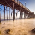 wooden pier above a misty sea