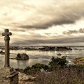 large cross monument in a coastal village