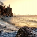 lighthouse on a fabulous rocky shore at sunset
