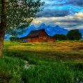 beautiful barn on the plains by a mountain range