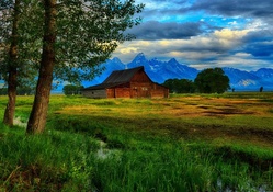 beautiful barn on the plains by a mountain range