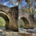 wonderful stone bridge over rapid river hdr