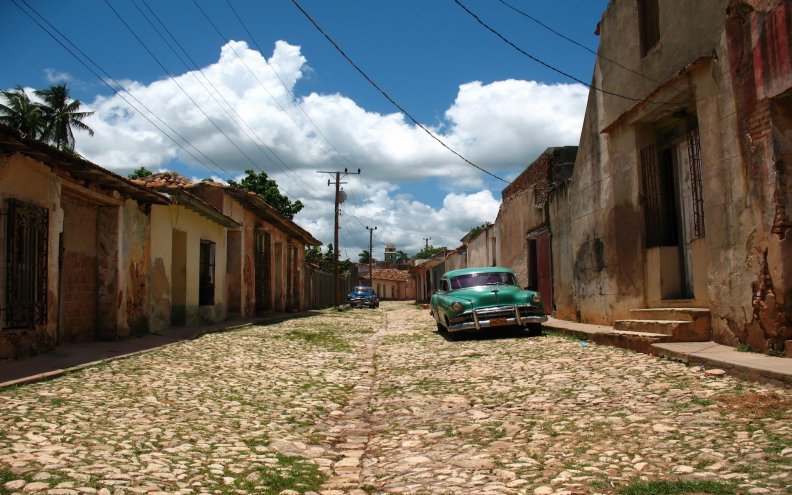 old_cars_on_a_street_in_a_cuban_town.jpg