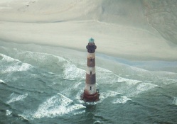 tall lighthouse off the beach