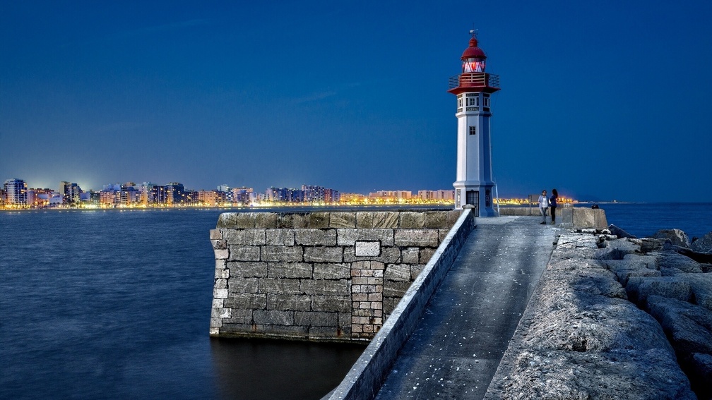 wonderful lighthouse at harbor entrance in spain