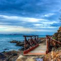 little wooden bridge over rocky seashore hdr