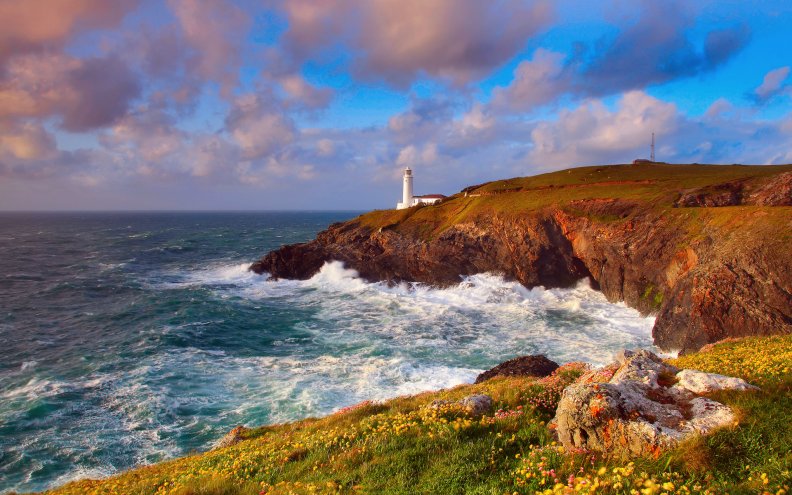 beautiful_lighthouse_over_a_rugged_seashore.jpg