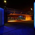 blue walls by a bridge at night