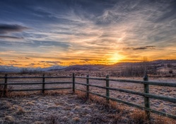 farm fence in the plains at sunset hdr