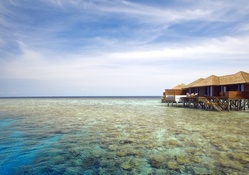 bungalows on a clear sea in the maldives