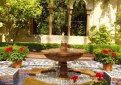 beautiful patio with flowers and fountain