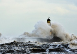 rough sea over a lighthouse pier