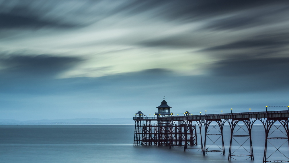 fantastic pier on a grey sea at dusk