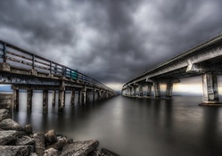 fishing pier by a highway bridge hdr