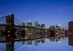 brooklyn bridge reflected in mirrored east river