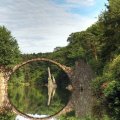 old bridge ruins make a circle in the river reflection