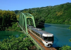 train crossing a bridge over a beautiful river