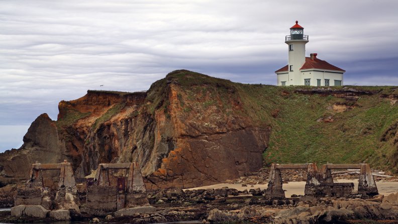 lighthouse on a cliff above a beach