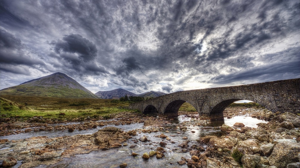 ancient stone bridge on a stone river hdr