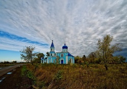 lovely blue orthodox church in the countryside