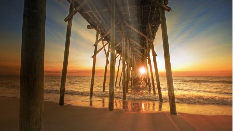 sunset under a wooden pier