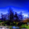 lovely bridge over a park pond in blue hue hdr