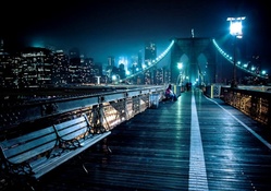 walkway on top of brooklyn bridge at night