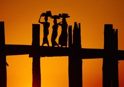 fantastic women's silhouete on a bridge at sunset