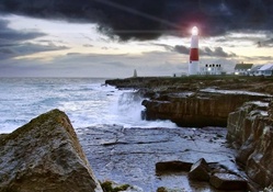 bright light lighthouse on a rough seashore