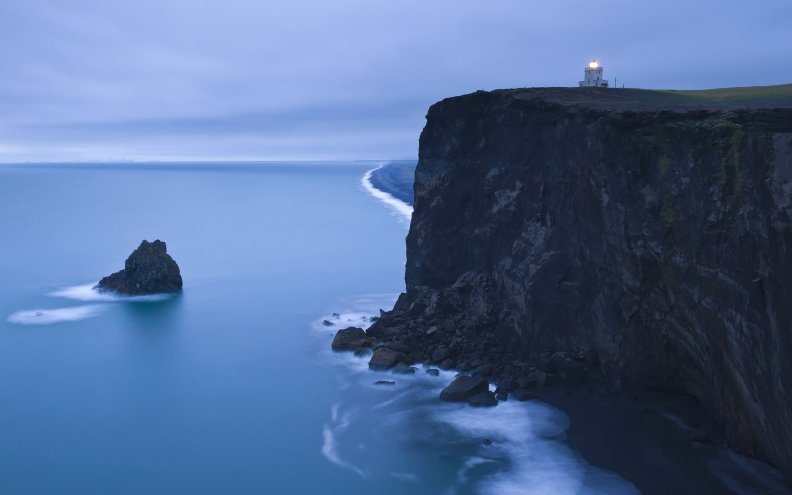 lighthouse over mystical seacoast