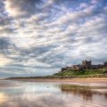 magnificent old castle on a hill above a beach hdr