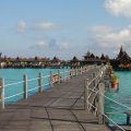 a pier to a bungalow resort in paradise