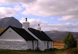 whitewashed stone cabin in the meadow
