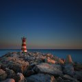 lighthouse on a stone pier in vilamoura portugal