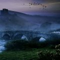 ancient bridge over a river in the mist