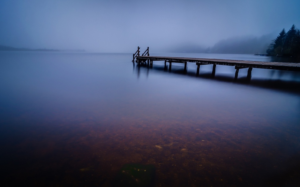 wonderful pier on a misty lake