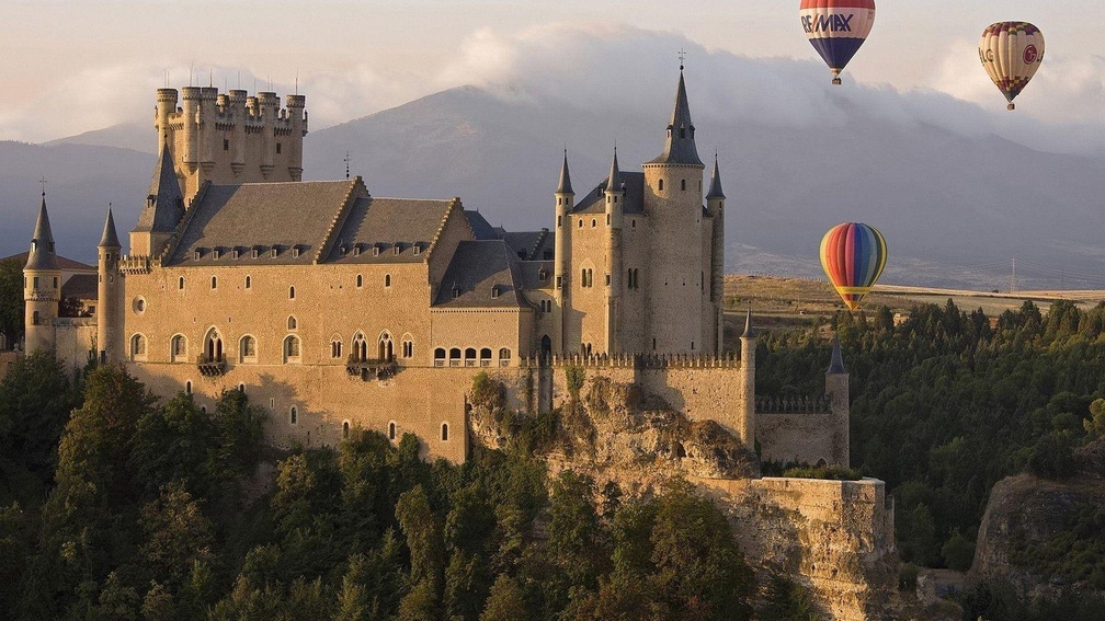 hot air balloons over a castle