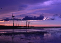 turbines on a beach under a magnificent sky