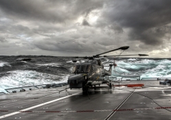 helicopter on a carrier in rough seas