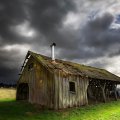 storm arriving on an old wooden cabin