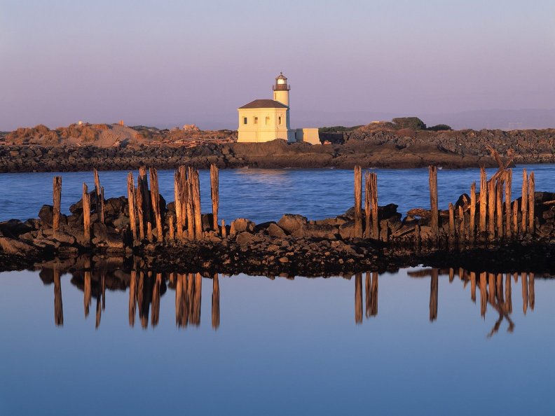 lighthouse on the low rocks coast