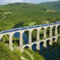 super train on and ancient bridge in france